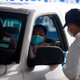 A healthcare worker talks to a person in line in their vehicle at United Memorial Medical Center Covid-19 testing site in Houston, Texas, June 25, 2020.
